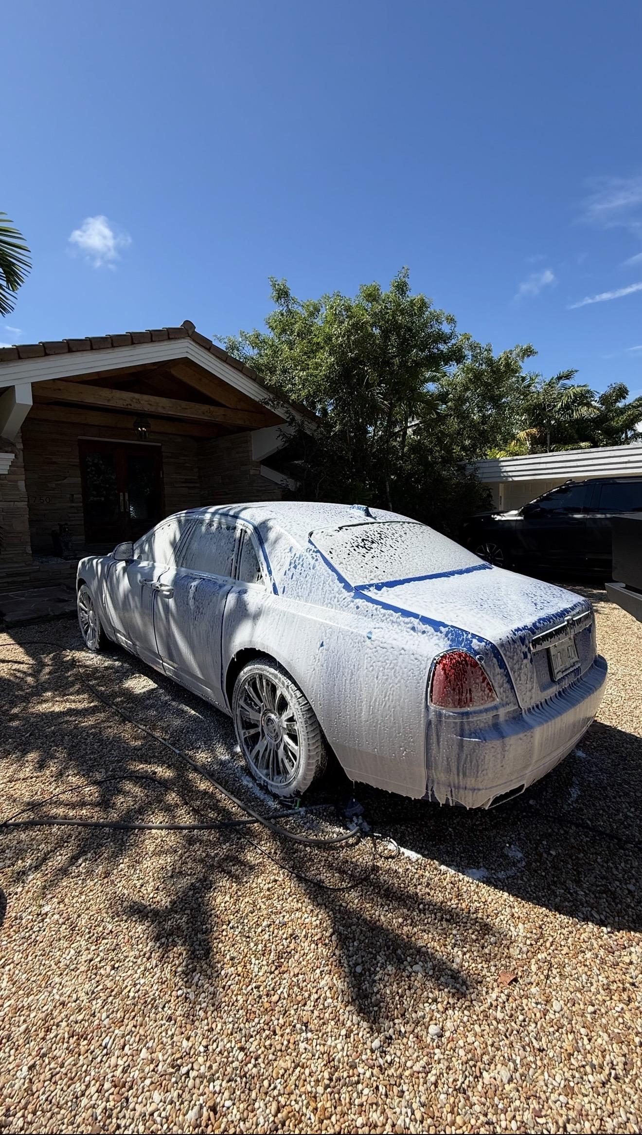 White foam pre-wash applied to vehicle during detailing process — Teal Detailing South Florida