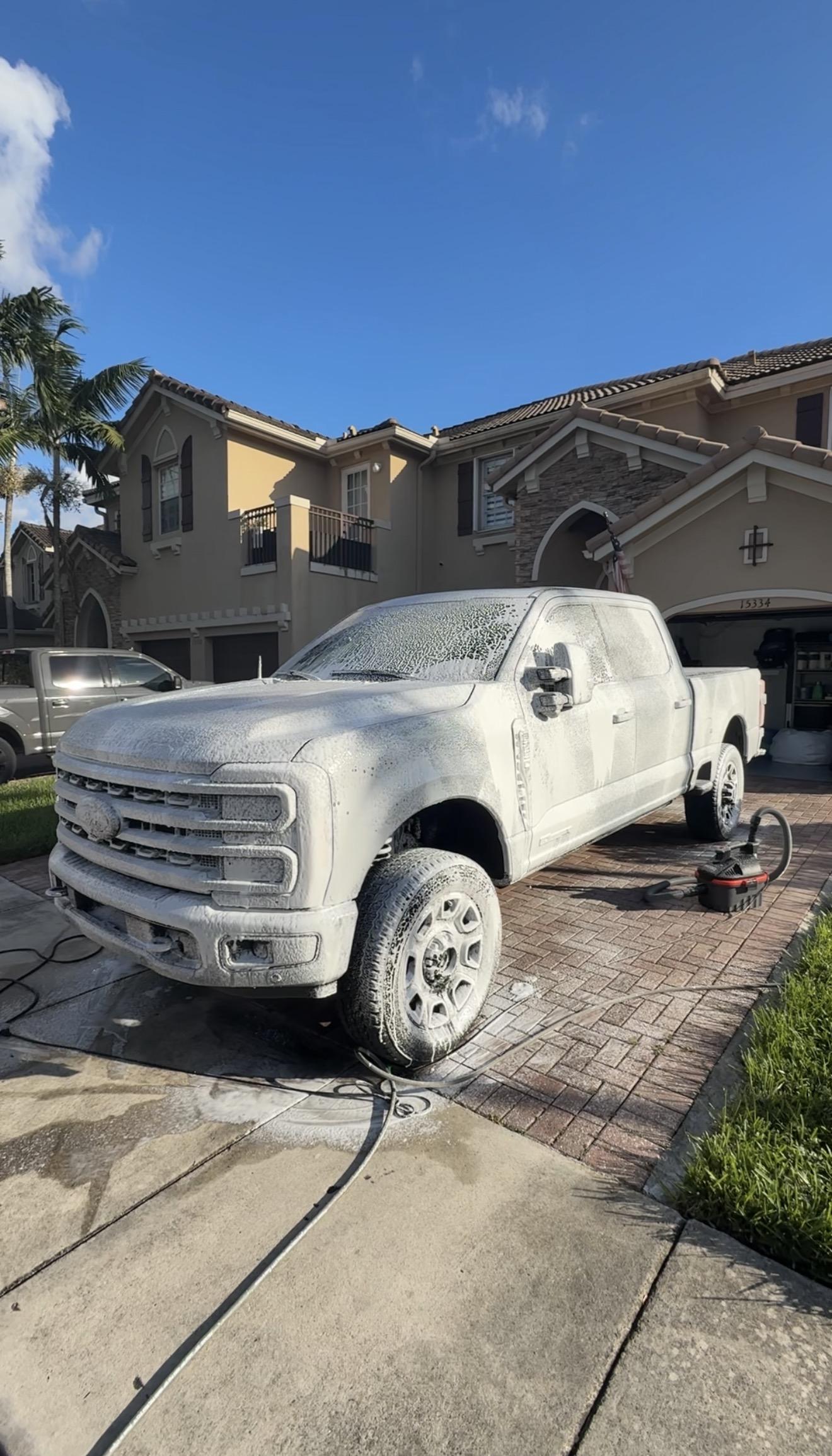 Foam treatment close-up on car panel — professional pre-soak for safe washing by Teal Detailing